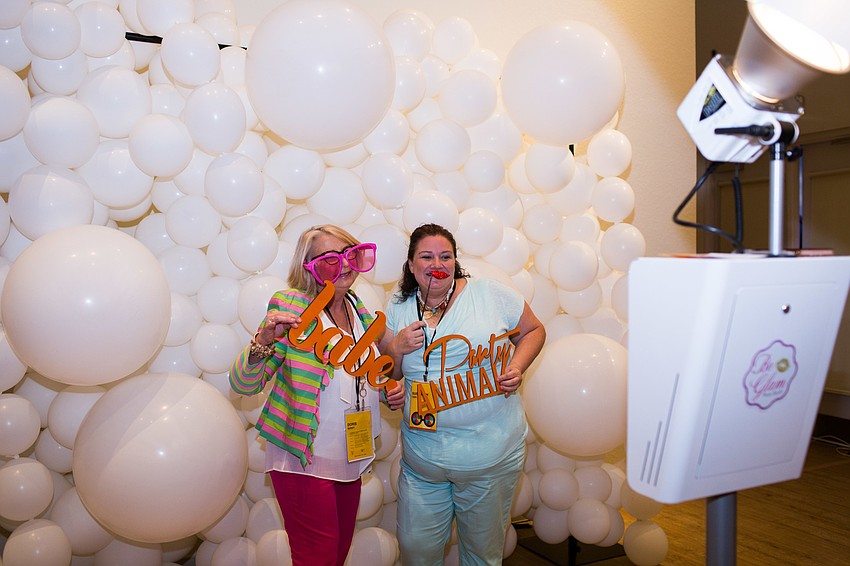 Doris Berkey and Susannah Cripe pose in BeGlam's photo booth.