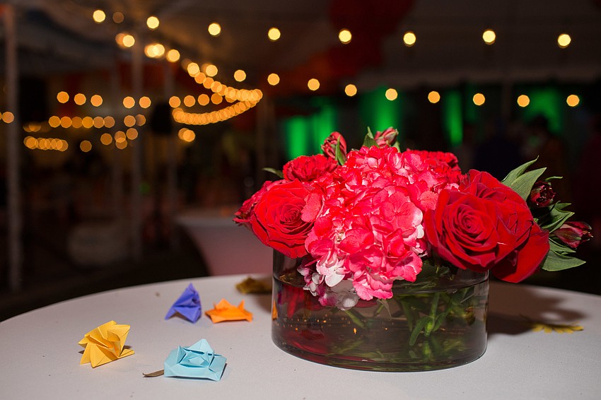 Each table had a white tablecloth and flowers in the respective color of the table theme.