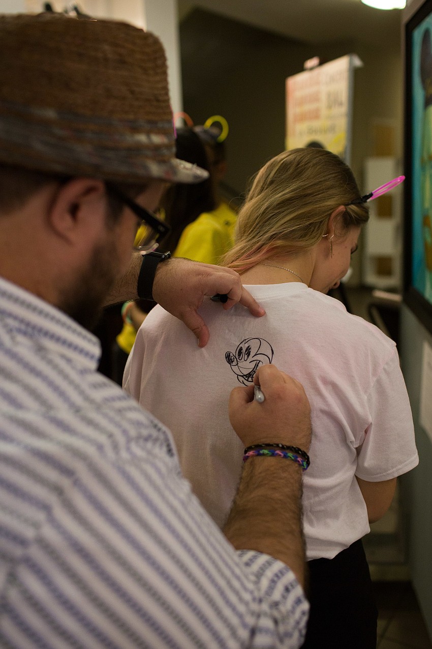 Tara Norten gets her shirt signed by Tim Rogerson.