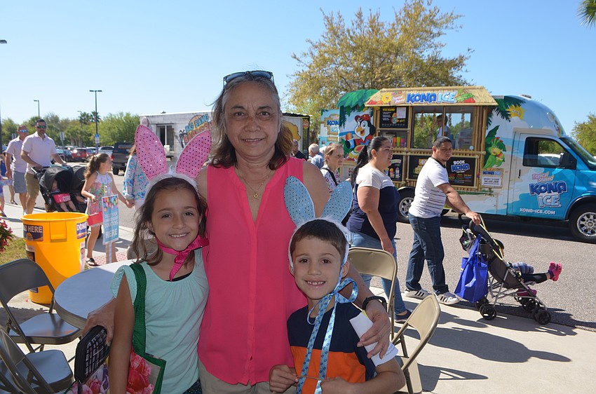 Eight-year-old Jade Liembach, Rosita Haas and 6-year-old Gabriel Liemback, of Greenbrook, wear their matching bunny ears.  Gabriel and Jade predict they're going to get between 100 and 1 million eggs.