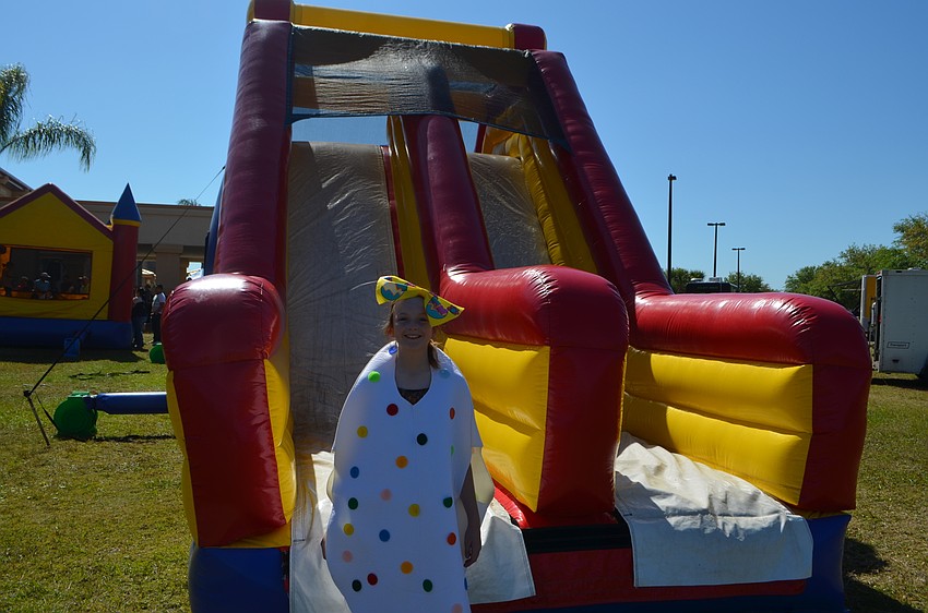 Audrey Yanevich, 11, dresses as a decorative egg while she helps run the bouncy slide for the kids.