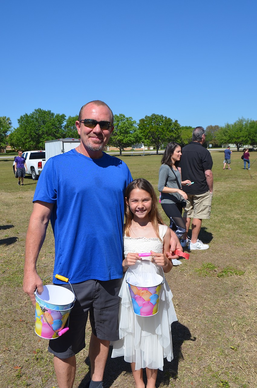 Michael Montgomery and his daughter Carissa, 9, from Greenbrook, try to pick out their spots for the egg hunt.