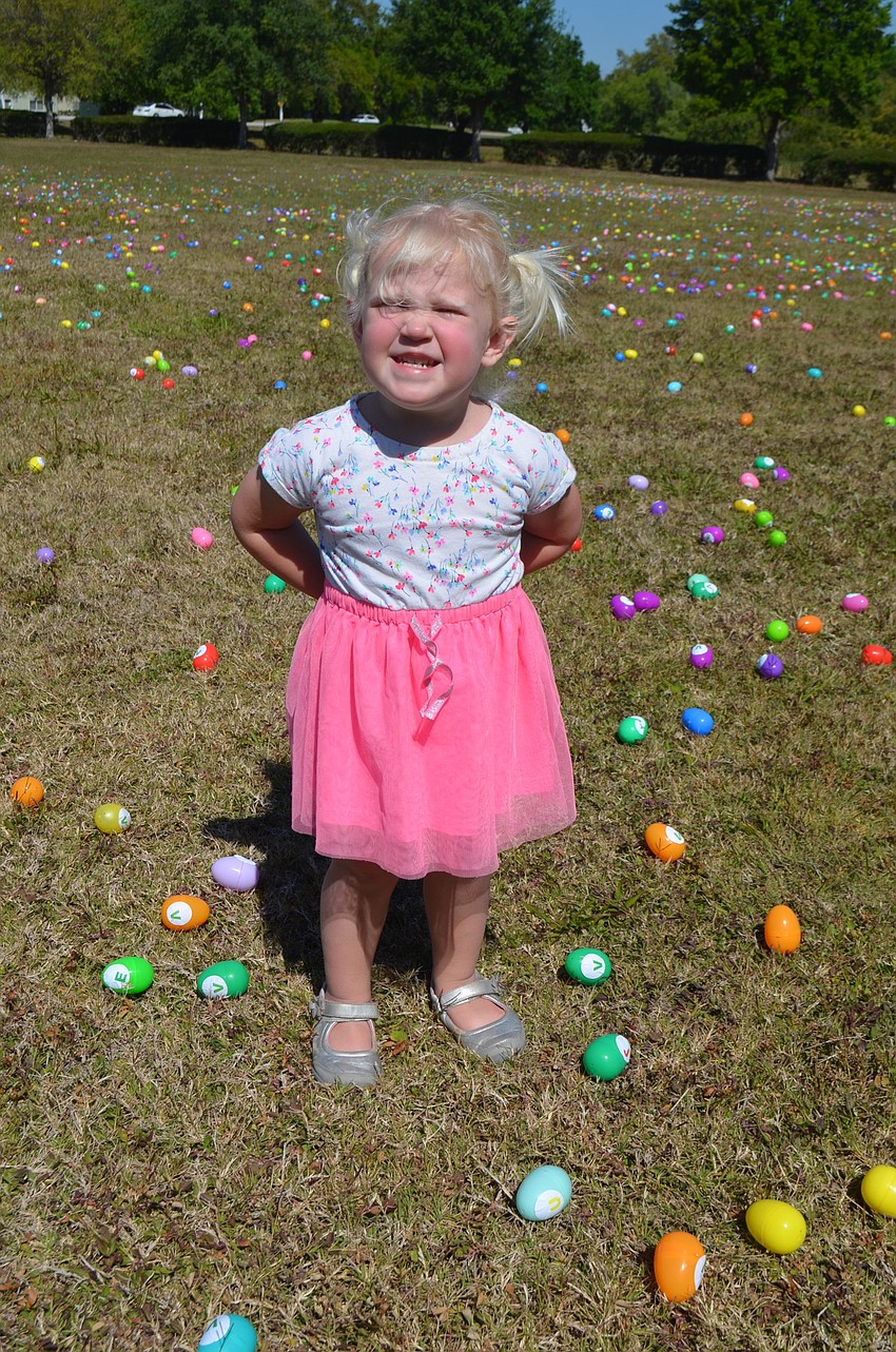 Two-year-old Sylvia Mcdonald, of Central Park, restrains herself from reaching down and grabbing an egg.