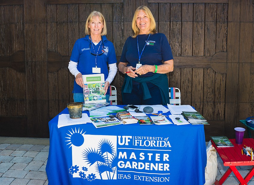 Irene McCarthy and Jane Smith answer questions visitors have about a garden on Clematis Street.