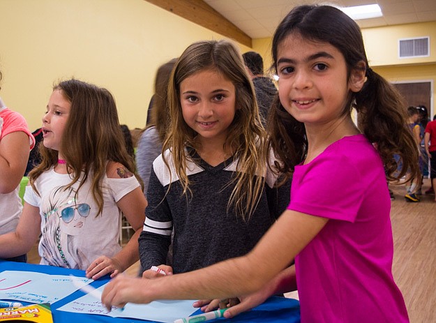 Dani Mallitz and Ava Rosin create Passover greeting cards that will be distributed to local nursing homes.