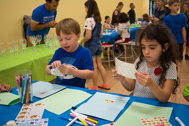 Benny Lebinger and Ari Ackerman create Passover greeting cards that will be distributed to local nursing homes.