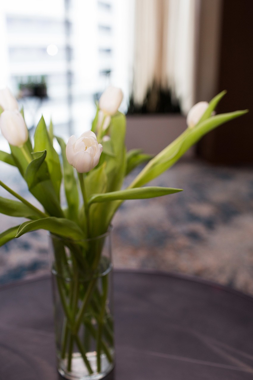 White tulips were arranged on each table.
