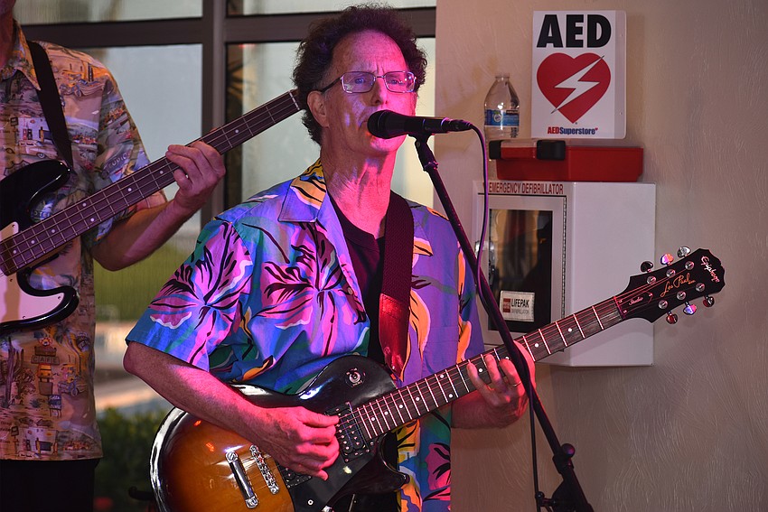 Ed Carter plays guitar and sings during the group’s performance at Islands West.