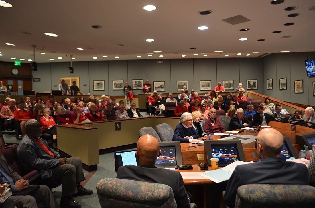 Supporters of the resident activist group STOP wore red to a March 15 commission meeting, urging the city to hold more public hearings on new development. Itâ€™s unclear how the commission will handle the issue.
