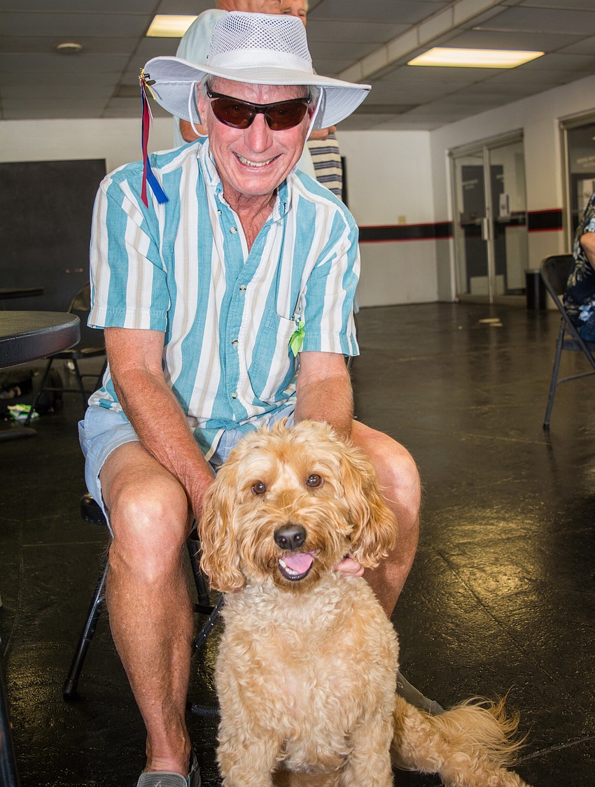 Jim Unnever with his Australian labradoodle Saidee, a past winner of the Mutt Derby.
