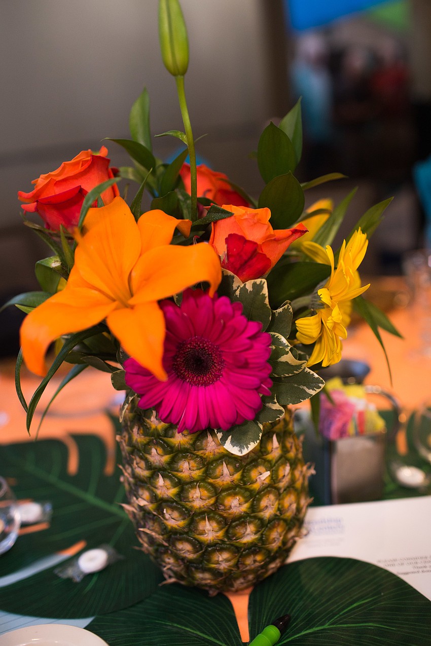 Each floral arrangement was placed in a pineapple.