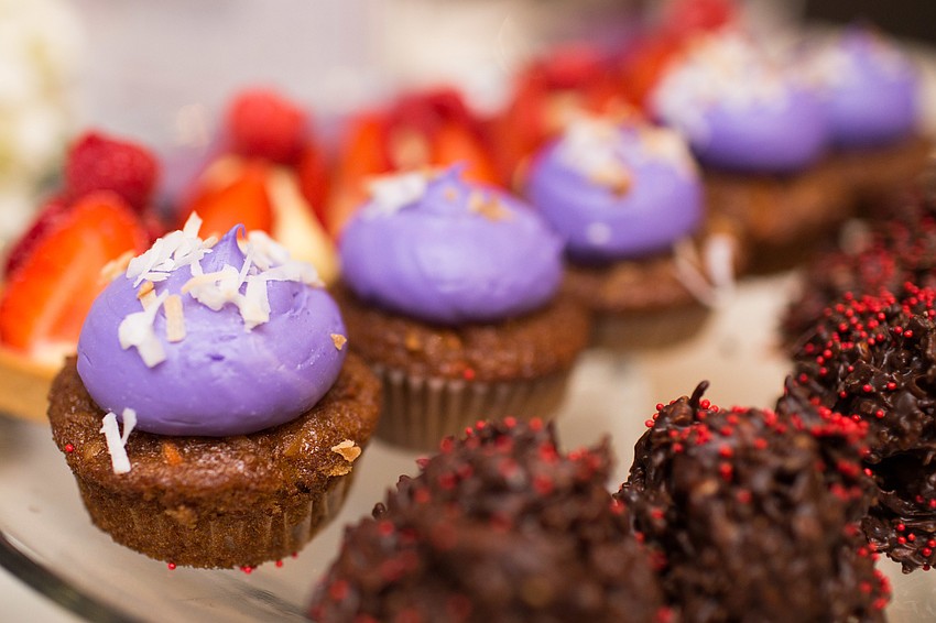 Desserts placed on each table fit with the pink and purple theme.
