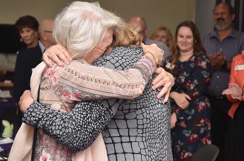 Jo Rutstein hugs her sister Frances Di Martino who surprised Rutstein by flying in town for her birthday.