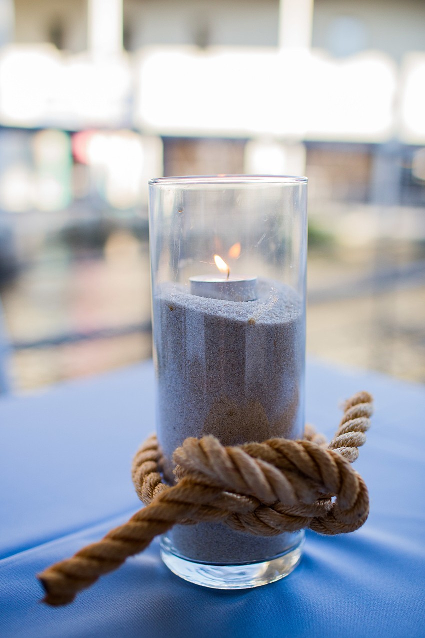 Tea candles in sand decorated the tables.