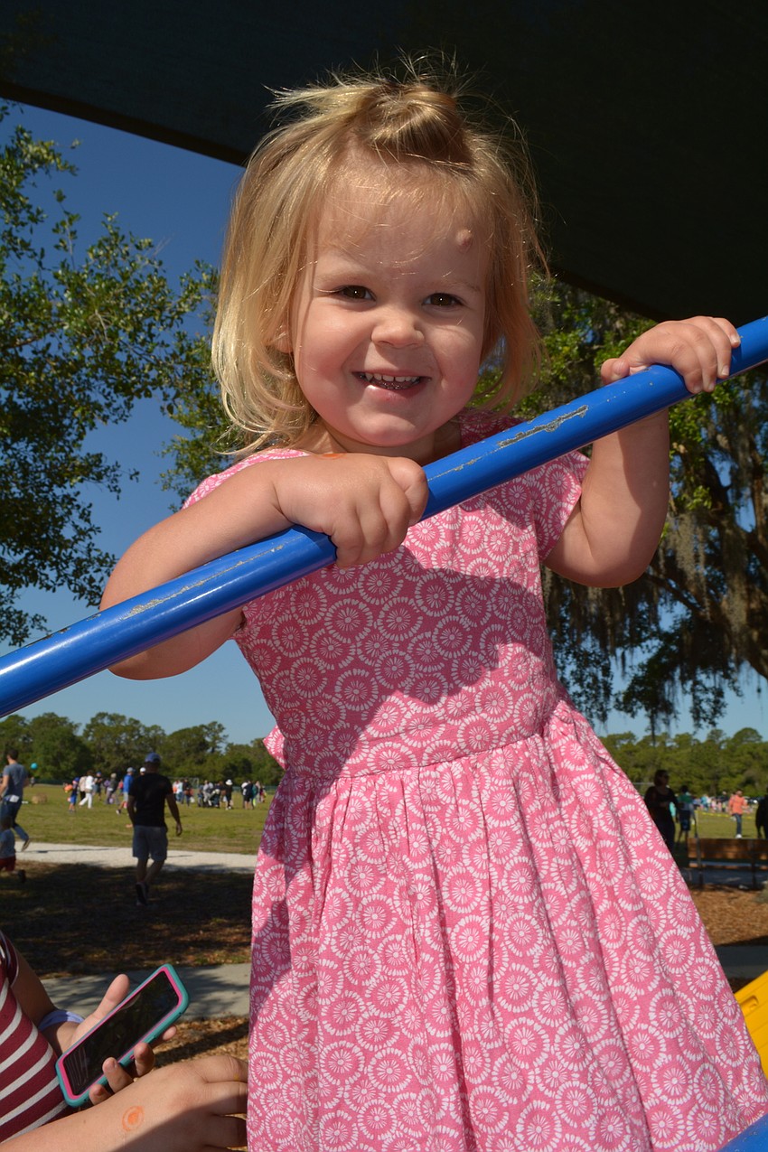 Two-year-old Sophia Schindler, of Rivers Reach, gets some action on the playground before lining up for the hunt.