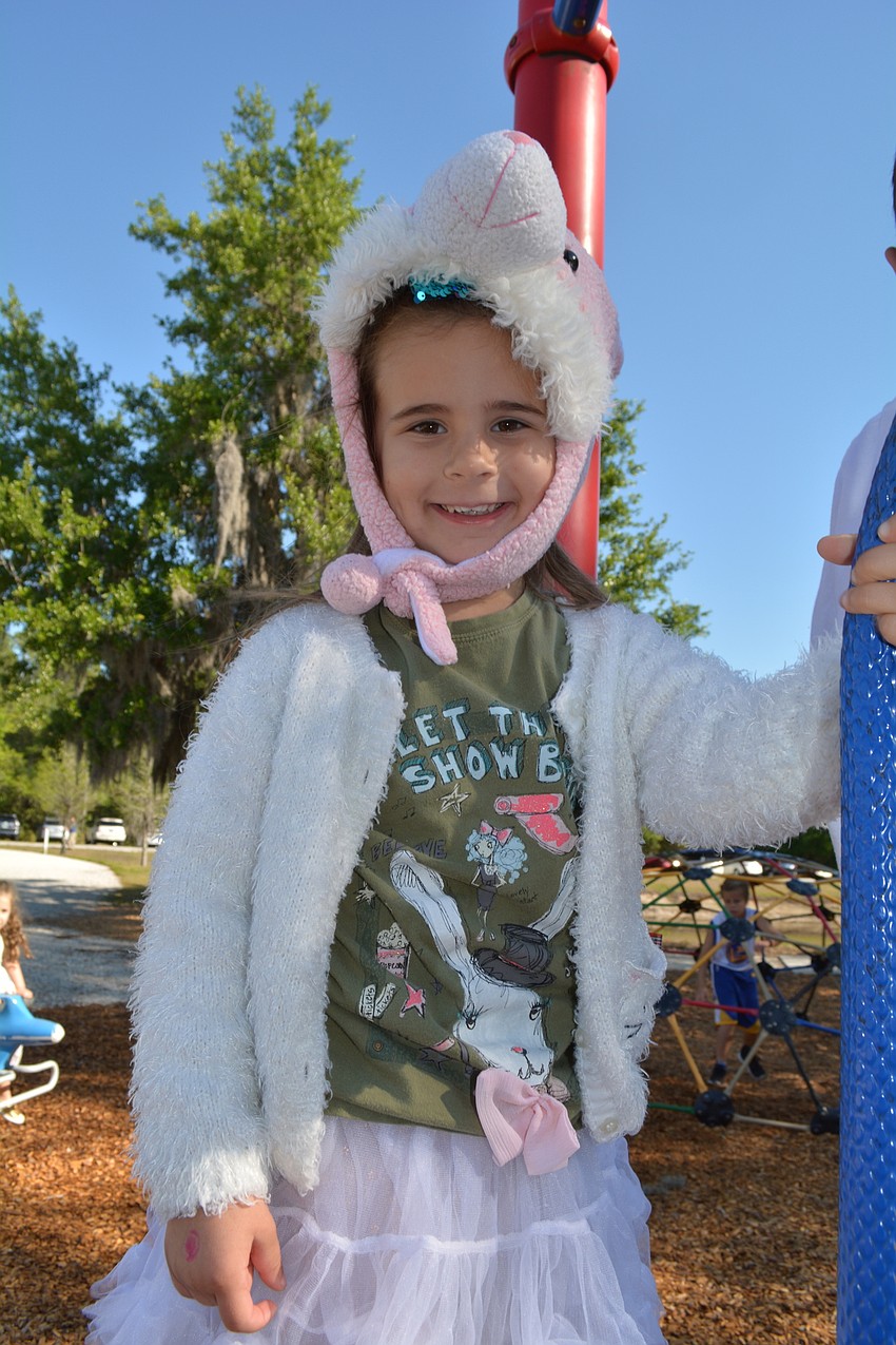 Four-year-old Vanessa Galliano, of River Club, plays on the playground before the hunt begins.