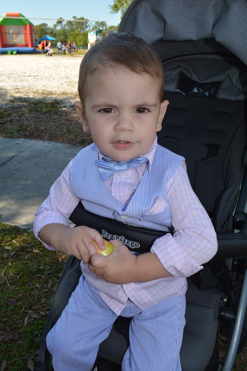 Mote Ranch's Brody Brown, 1, watches his 3-year-old sister Gracie open eggs for prizes.