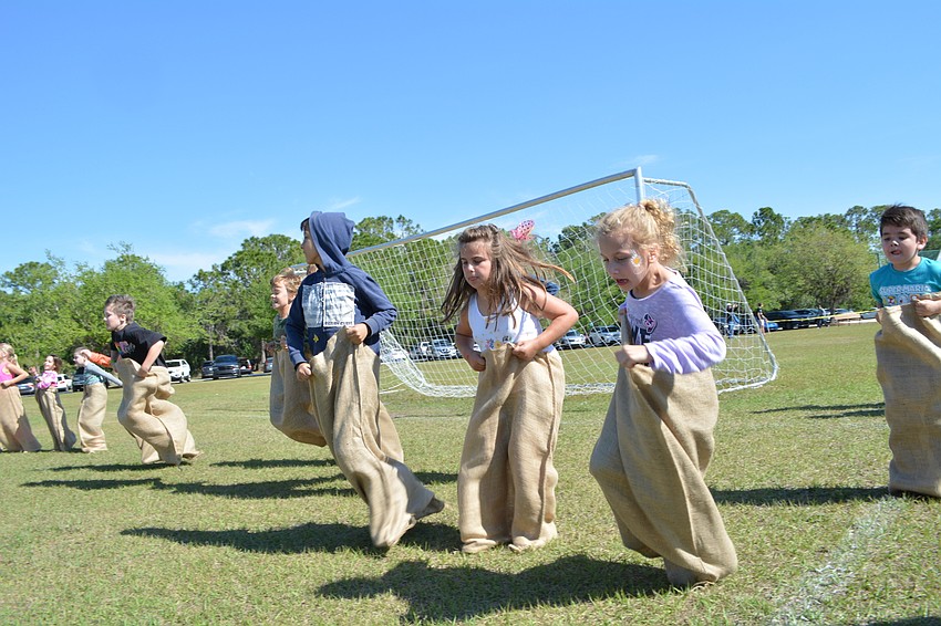 Children who found certain eggs won a chance to participate in a  potato sack race.