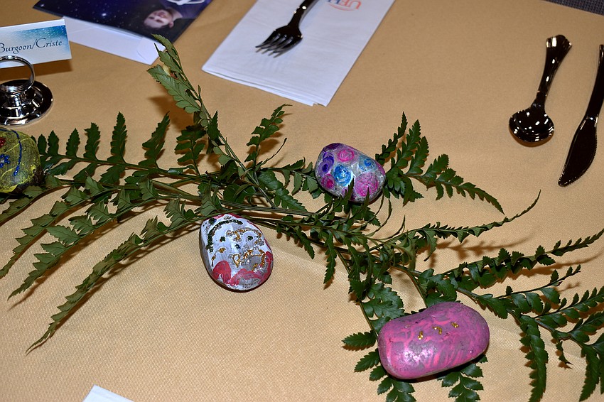 Rocks painted by patients at the University of Florida Health Cancer Center adorned each table.