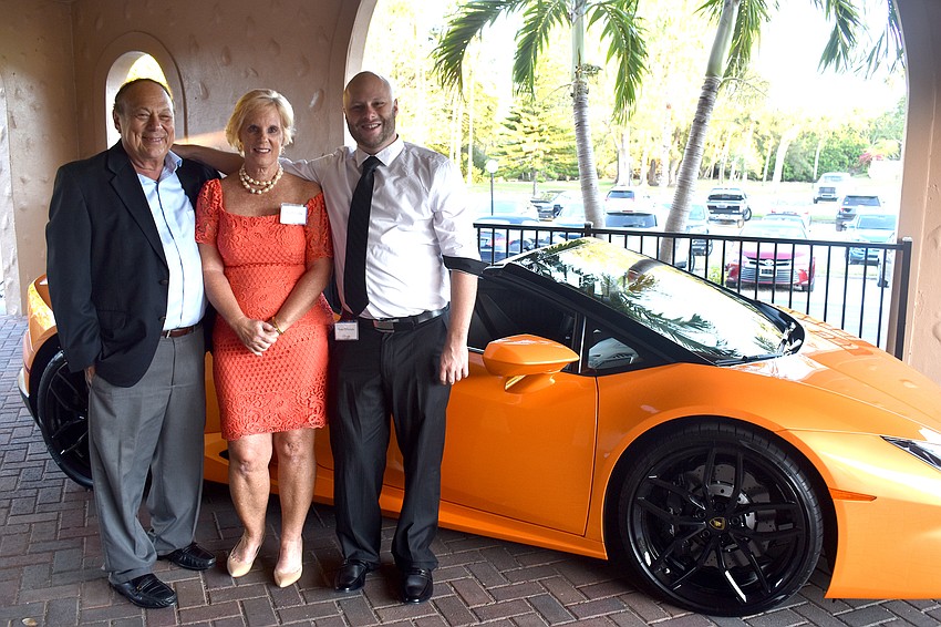 Chuck, Sue and Tom DiNatale stand next to a Lamborghini, a favorite car of Dan DiNatale.