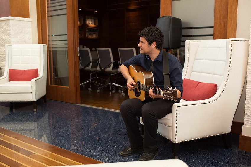 Jason Hobert plays the guitar during cocktail hour.