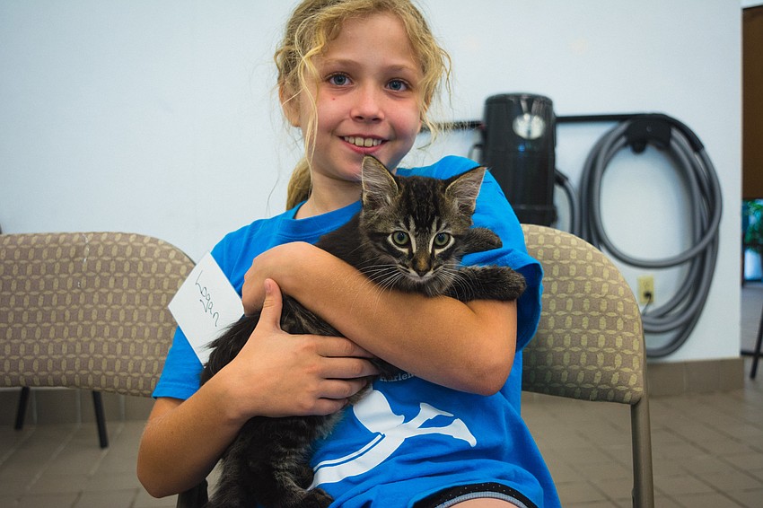 Logan Schaab with a cat.