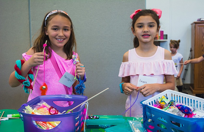 Abigail Dipinto and Amara Oliva make toys for the cats and dogs at the Humane Society of Sarasota County.