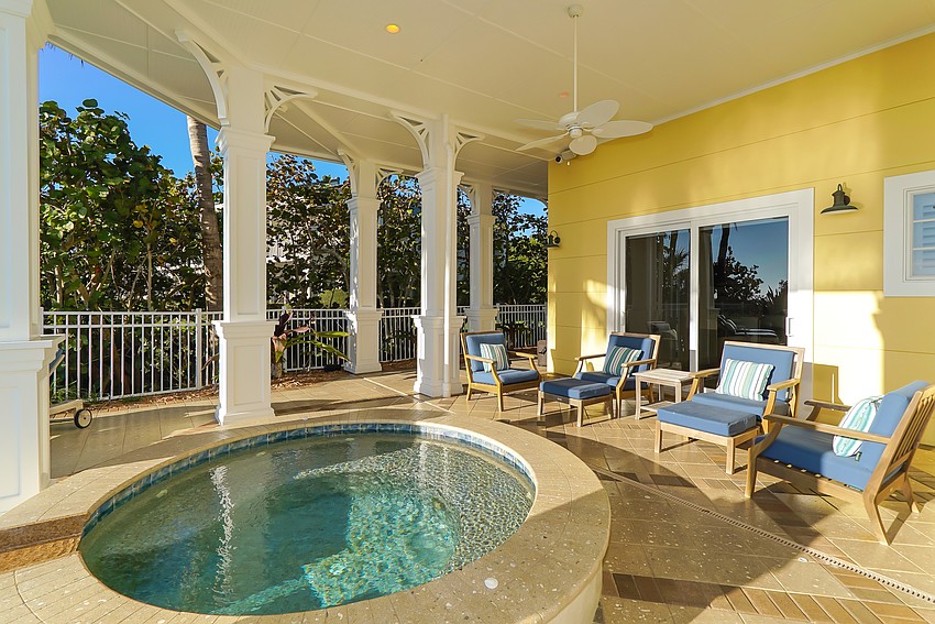 A hot tub and pool overlook the beach.