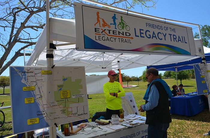 John League, left, discusses the proposed Legacy Trail extension on Saturday at Payne Park.