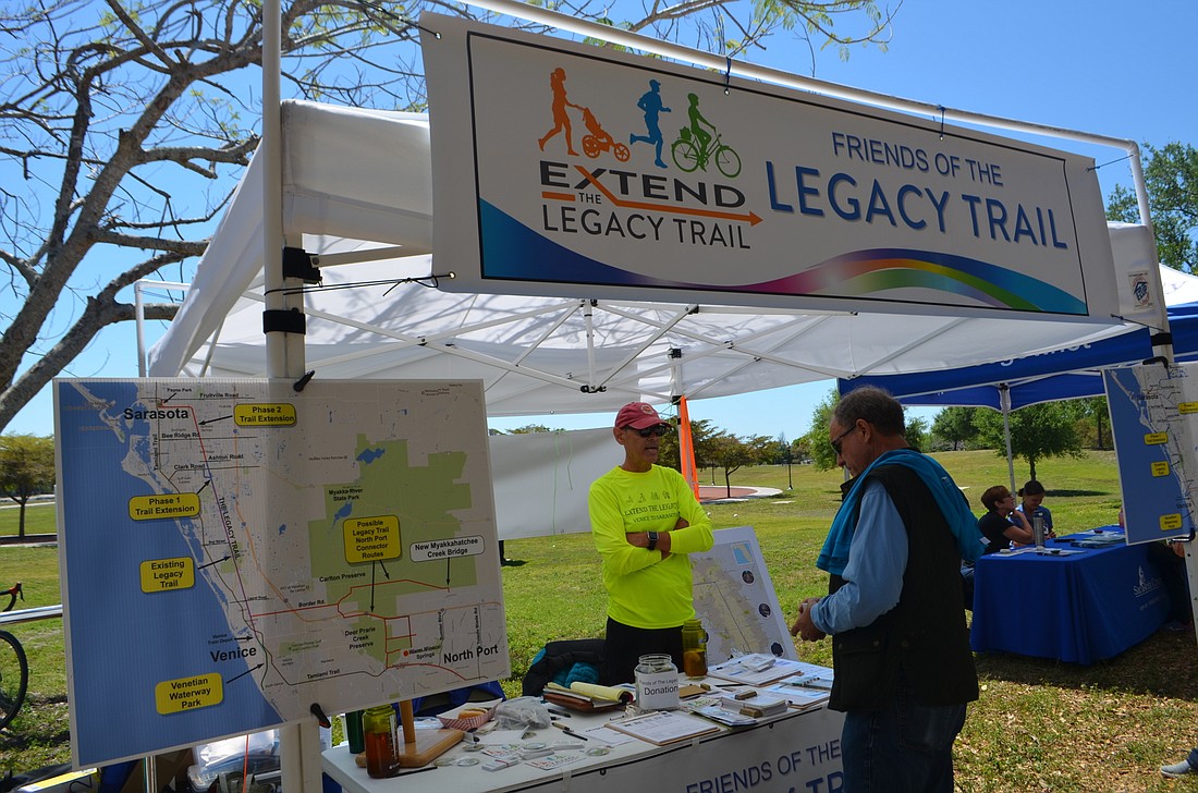 John League, left, discusses the proposed Legacy Trail extension on Saturday at Payne Park.
