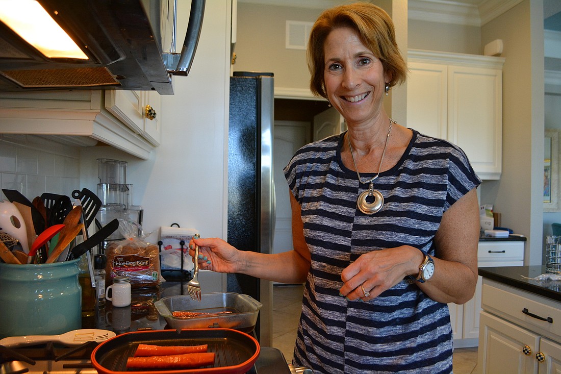 Central Park resident Heidi Schild says she feels healthier since she began eating a plant-based diet a year ago. She cooks up marinated carrots for a dinner of  "carrot dogs."