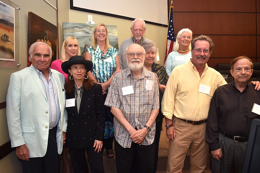 The 10 artists stand with Mayor George Spoll.