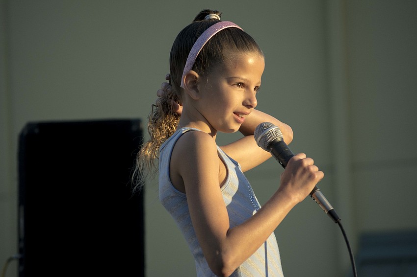 Sixth-grader Nadia El Mahdi sang a song and kept her hair in place.