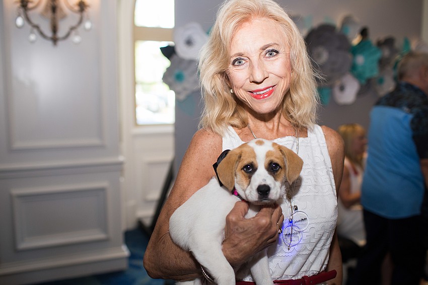 Barbara Verhey poses with a nine-week-old puppy.