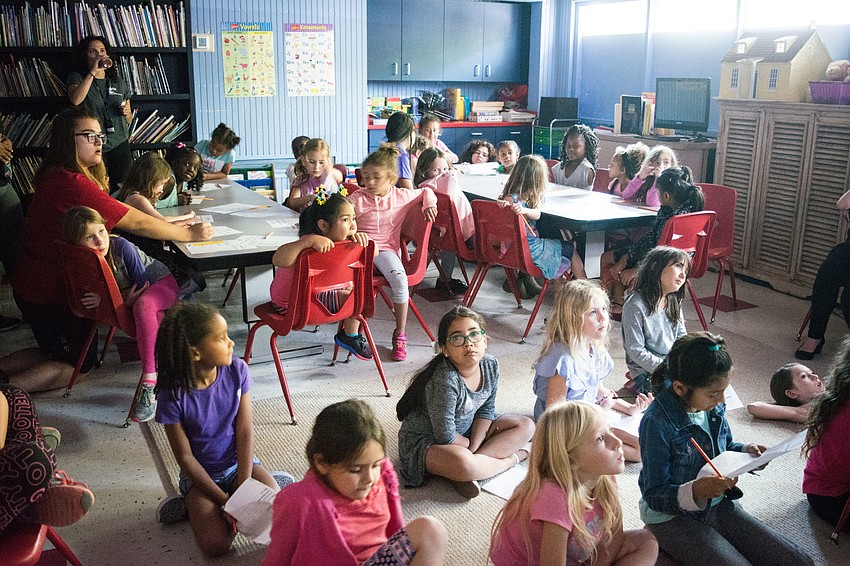 Boys and Girls Club members watch films with Girls Inc. students.