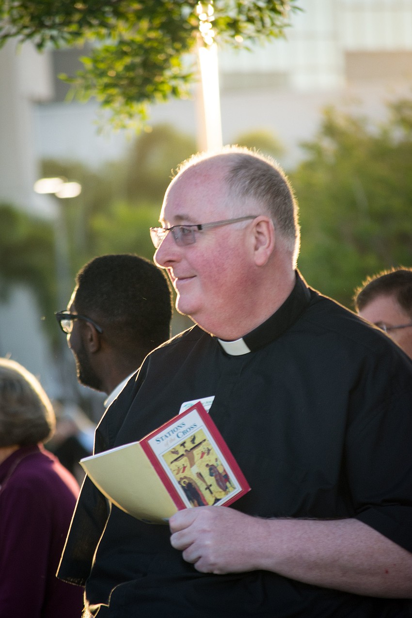 Church of Saint Patrick's Rev.  Russell Wright prays with the crowd.