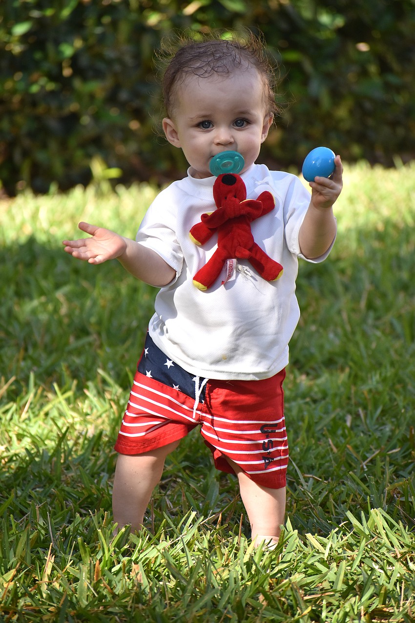 Benjamin Honroth holds up an Easter egg.