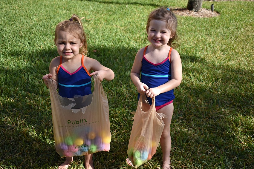 Abby Honroth and Emily Krusemark show off the eggs they found during the egg hunt.