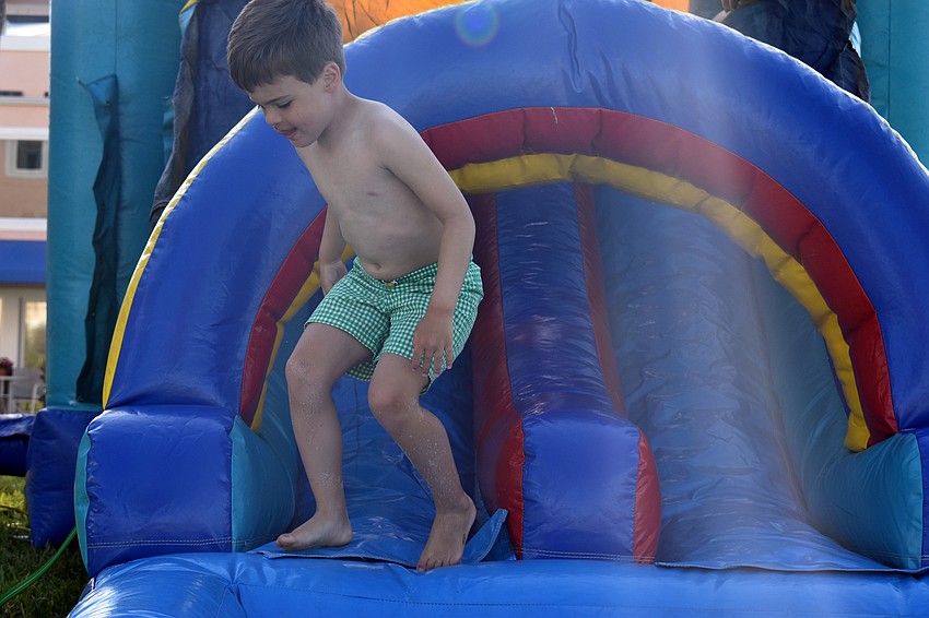 Connor Whitson jumps off the bounce house.