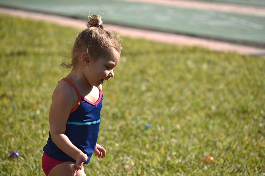 Abby Honroth runs around Sand Cay’s property searching for Easter eggs.
