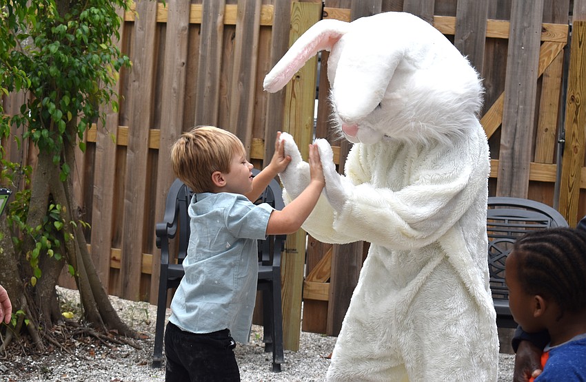 Shane Bradley high-fives the Easter bunny.