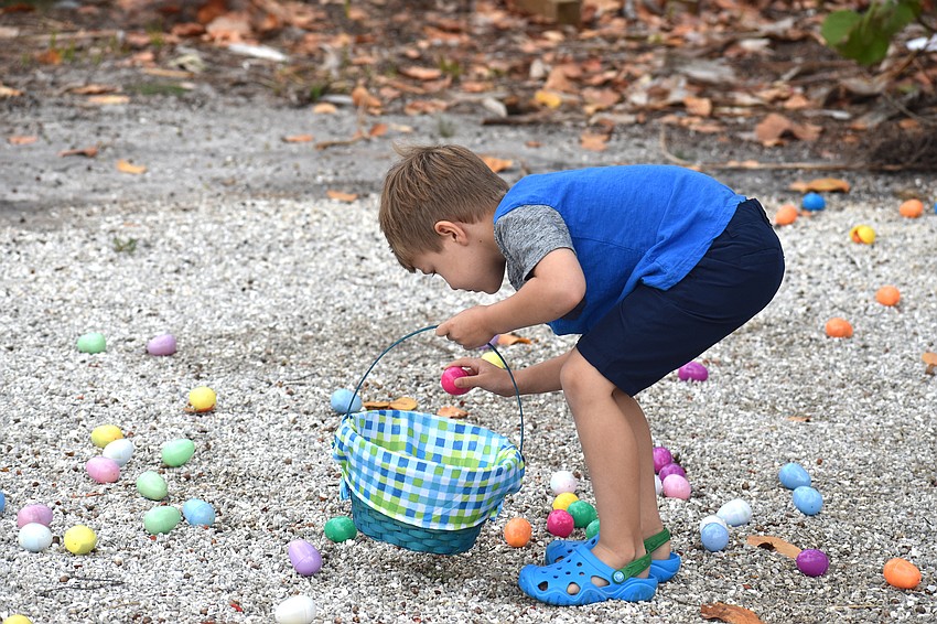 Gavin Zinck fills his basket with Easter eggs.
