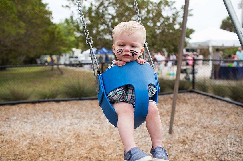 David Weber swings on the playground.