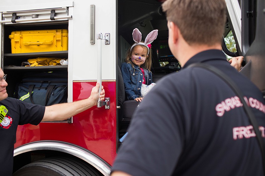Lyla Oschsendorf sits in a firetruck.