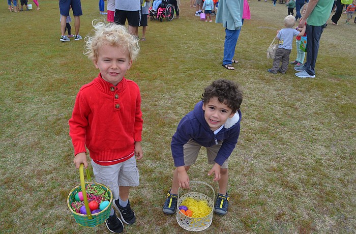 Connor Whisenant, 3, and Patrick Cannon, 3 count their eggs after the Easter egg hunt.