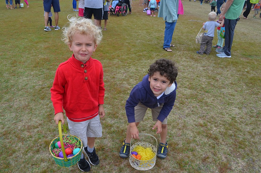 Connor Whisenant, 3, and Patrick Cannon, 3 count their eggs after the Easter egg hunt.