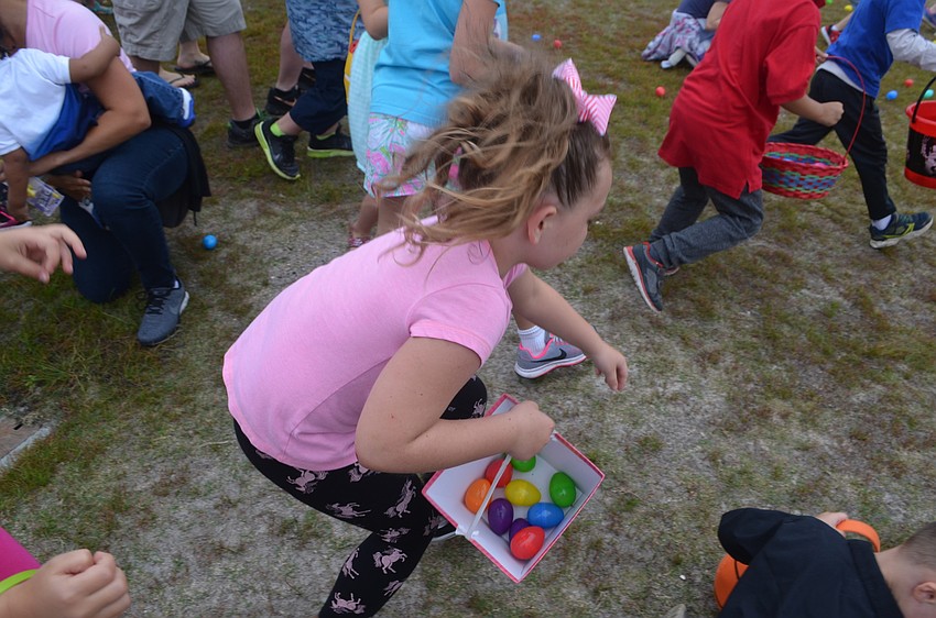 Lakewood Ranch's Kylie Lawson, 7, tries to grab as many eggs as she can.