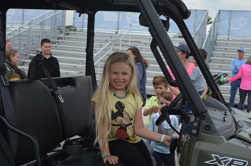 Sarasota's Ava Claire Forchetti, 6, smiles as she sits in an off terrain vehicle.