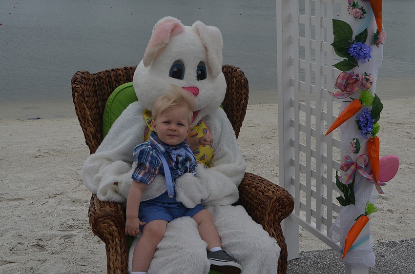 Bradenton's Caiden Salkill, 14 months, gets a quick picture taken with the Easter bunny.