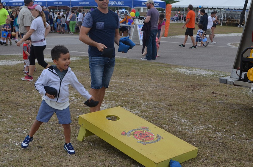 Sarasota's Liam Dube plays cornhole with his father.